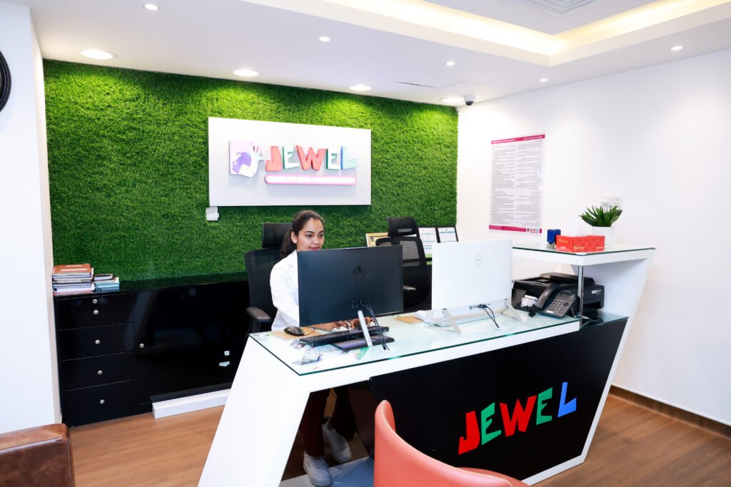 Reception area of Jewel Autism Center, the best behaviour therapy center in Dubai UAE, with a modern design and a staff member at the front desk.