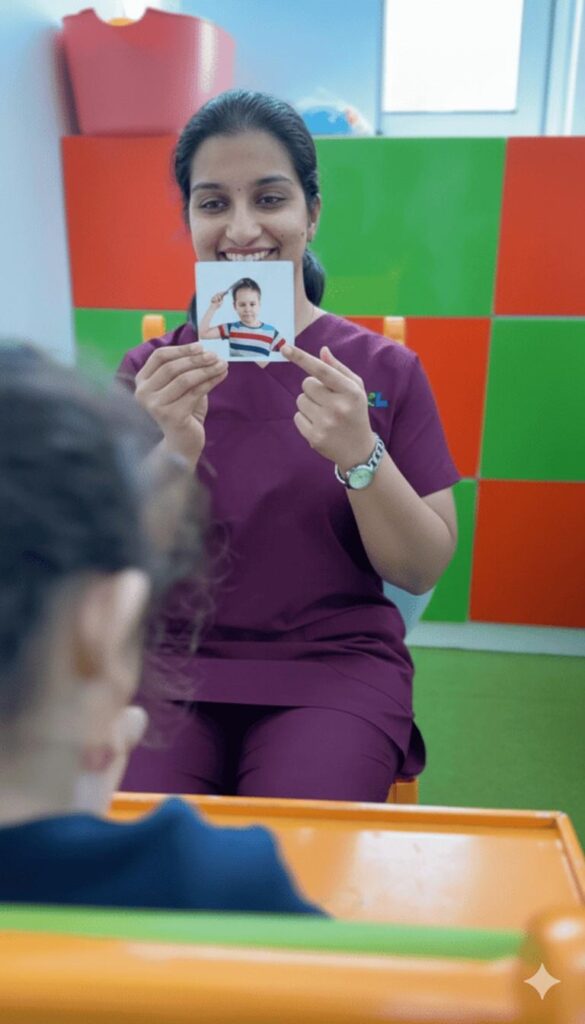 Speech therapist at Jewel Autism and Child Development Center using picture cards to enhance a child’s language and communication skills at the best speech therapy center in Dubai.